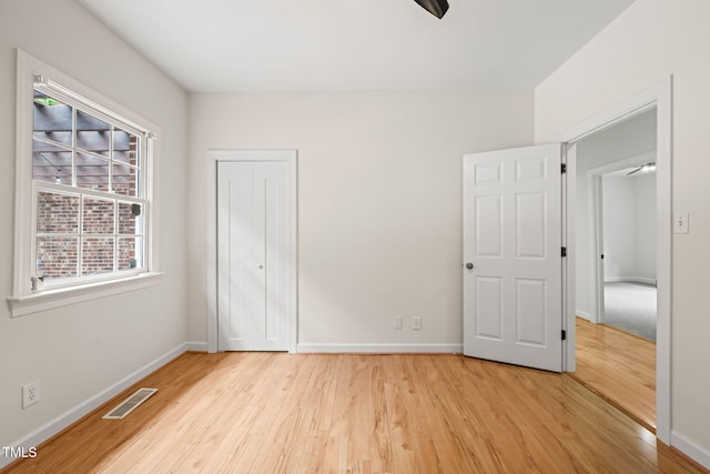 1514 Lawrence Rd, Creedmoor, NC 27522 - unfurnished bedroom with light wood-style flooring, baseboards, and a closet