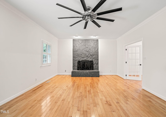1514 Lawrence Rd, Creedmoor, NC 27522 - unfurnished living room featuring crown molding, hardwood / wood-style flooring, a stone fireplace, a ceiling fan, and baseboards
