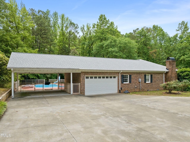 1514 Lawrence Rd, Creedmoor, NC 27522 - view of front facade featuring driveway, a garage, a carport, a chimney, and brick siding
