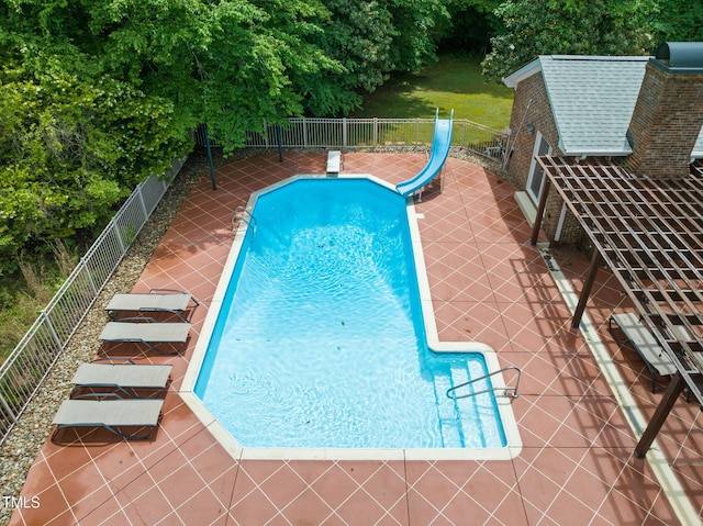 1514 Lawrence Rd, Creedmoor, NC 27522 - view of swimming pool featuring a patio area, a water slide, a fenced backyard, and view of wooded area