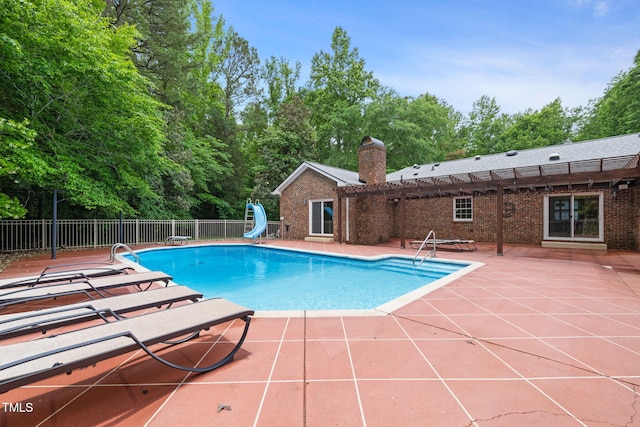 1514 Lawrence Rd, Creedmoor, NC 27522 - view of pool with a water slide, a patio area, a pergola, and view of scattered trees