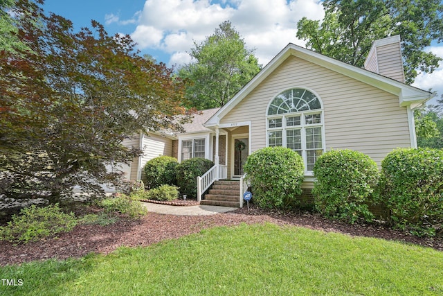 1102 Laurens Way, Knightdale, NC 27545 - view of front of home featuring a chimney, a front yard, and a garage