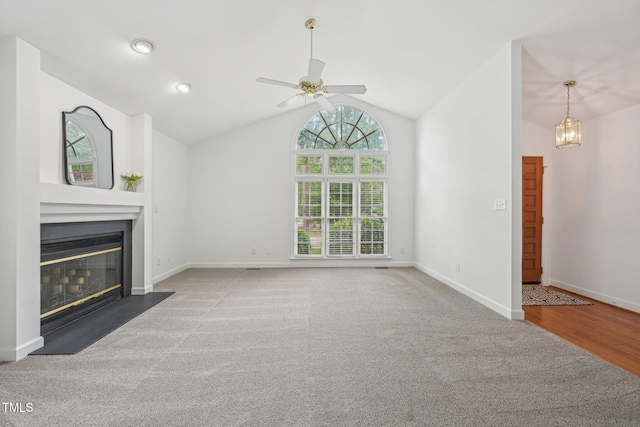 1102 Laurens Way, Knightdale, NC 27545 - unfurnished living room featuring a fireplace with flush hearth, a ceiling fan, vaulted ceiling, baseboards, and carpet floors