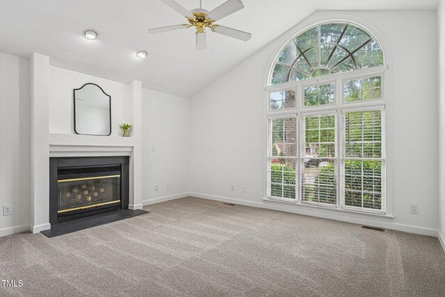 1102 Laurens Way, Knightdale, NC 27545 - unfurnished living room featuring carpet, a fireplace with flush hearth, a ceiling fan, baseboards, and high vaulted ceiling