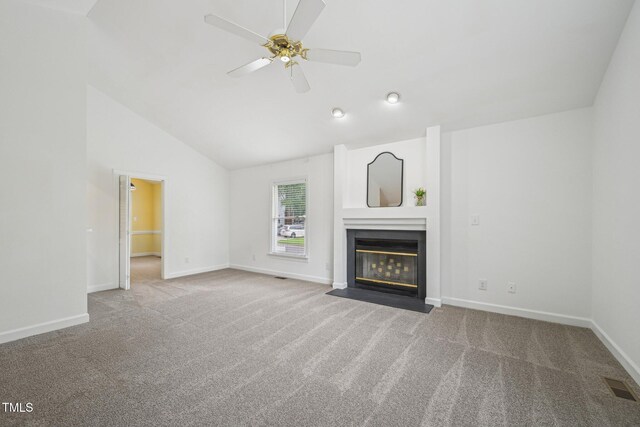 1102 Laurens Way, Knightdale, NC 27545 - unfurnished living room featuring carpet flooring, a ceiling fan, a fireplace with flush hearth, baseboards, and high vaulted ceiling