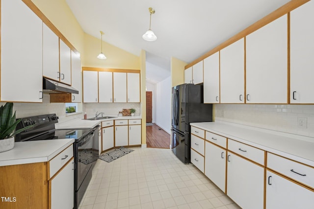 1102 Laurens Way, Knightdale, NC 27545 - kitchen with black appliances, under cabinet range hood, vaulted ceiling, light countertops, and decorative backsplash