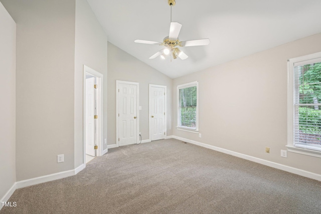 1102 Laurens Way, Knightdale, NC 27545 - unfurnished bedroom with carpet, multiple windows, lofted ceiling, and baseboards