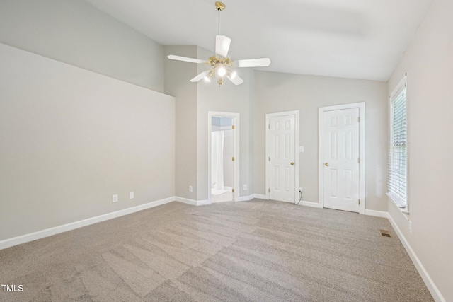 1102 Laurens Way, Knightdale, NC 27545 - unfurnished bedroom featuring carpet floors, vaulted ceiling, connected bathroom, baseboards, and a ceiling fan