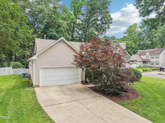 1102 Laurens Way, Knightdale, NC 27545 - view of front of house featuring central AC, concrete driveway, roof with shingles, and a garage