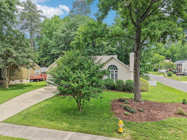1102 Laurens Way, Knightdale, NC 27545 - view of property hidden behind natural elements with a front yard, a chimney, and concrete driveway