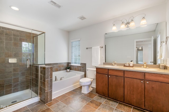 bathroom featuring a bath, a shower stall, double vanity, and toilet