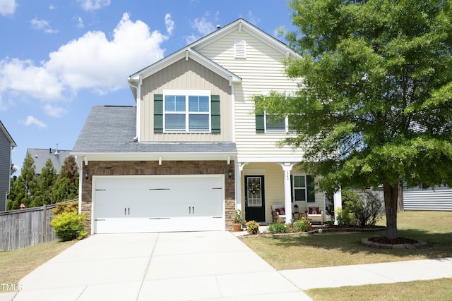 craftsman-style home featuring a porch, board and batten siding, driveway, stone siding, and a garage