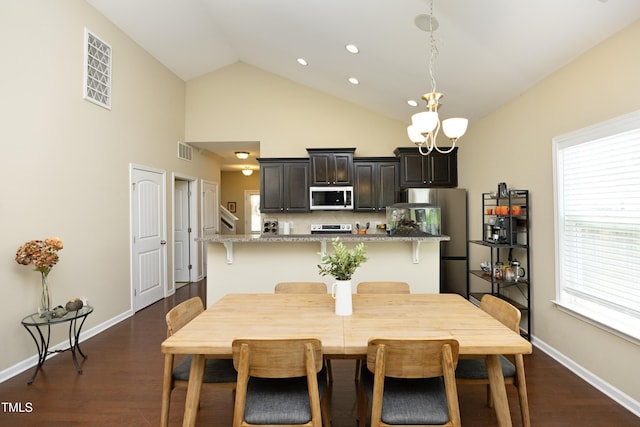 dining space with dark wood finished floors, a chandelier, plenty of natural light, high vaulted ceiling, and recessed lighting