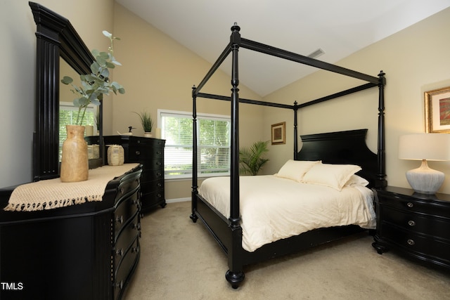 bedroom featuring light colored carpet, lofted ceiling, and baseboards