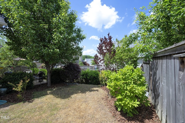 view of yard featuring fence and a patio