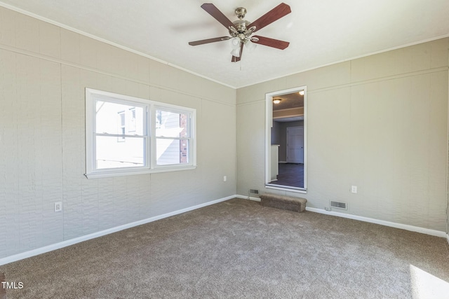unfurnished bedroom featuring crown molding, carpet floors, baseboards, and ceiling fan