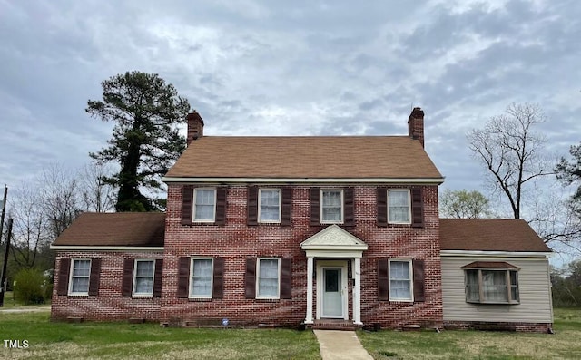 1609 Main St, Scotland Neck, NC 27874 - colonial inspired home with a chimney, a front lawn, and brick siding