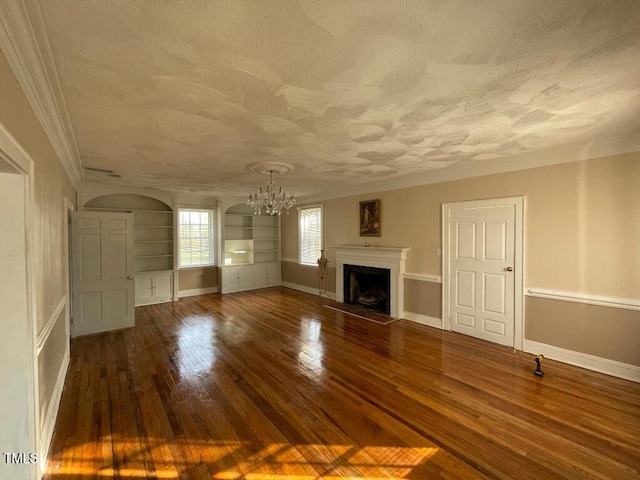 1609 Main St, Scotland Neck, NC 27874 - unfurnished living room with a chandelier, a textured ceiling, wood finished floors, a fireplace, and baseboards