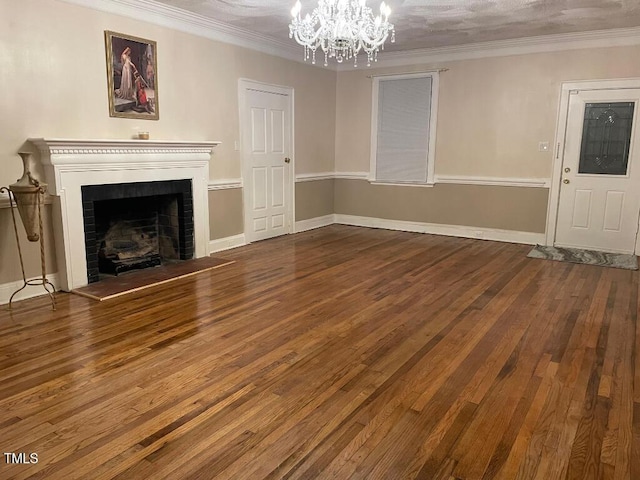 1609 Main St, Scotland Neck, NC 27874 - unfurnished living room with a chandelier, hardwood / wood-style flooring, a fireplace, ornamental molding, and baseboards