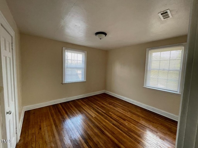 1609 Main St, Scotland Neck, NC 27874 - unfurnished bedroom with dark wood-style flooring and baseboards