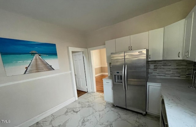 1609 Main St, Scotland Neck, NC 27874 - kitchen featuring stainless steel fridge with ice dispenser, white cabinetry, light marble finish floors, and backsplash