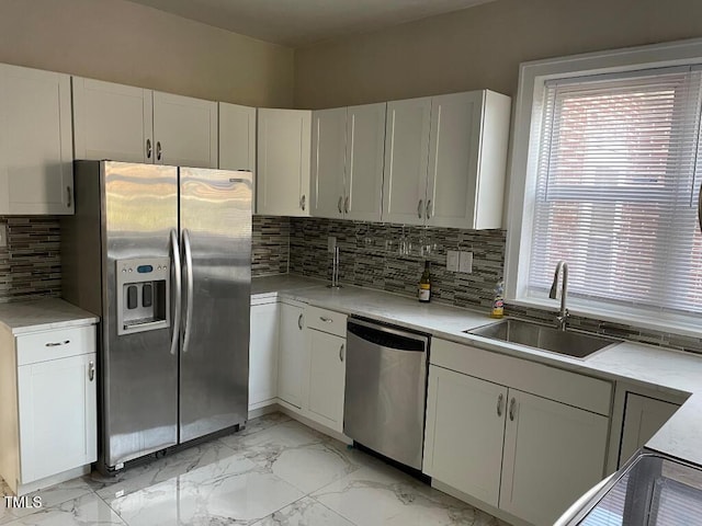 1609 Main St, Scotland Neck, NC 27874 - kitchen featuring stainless steel appliances, a sink, light marble finish floors, and white cabinetry