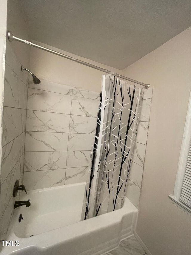 1609 Main St, Scotland Neck, NC 27874 - bathroom with shower / bath combination with curtain, marble look tiles, and baseboards