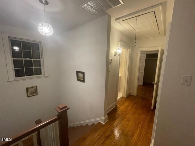 1609 Main St, Scotland Neck, NC 27874 - hallway featuring hardwood / wood-style flooring, an upstairs landing, baseboards, and a chandelier