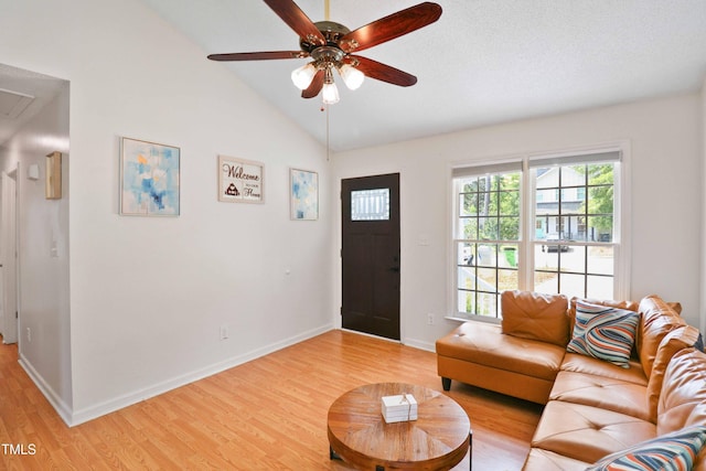 1508 Malta Ave, Raleigh, NC 27610 - living area featuring light wood-style flooring, lofted ceiling, baseboards, ceiling fan, and attic access