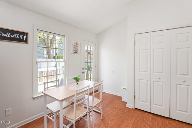 1508 Malta Ave, Raleigh, NC 27610 - dining room with lofted ceiling, light wood-style flooring, and baseboards