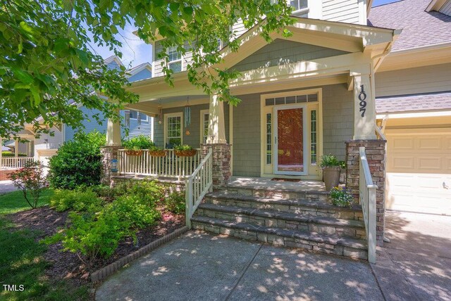 property entrance with a porch, a shingled roof, and a garage