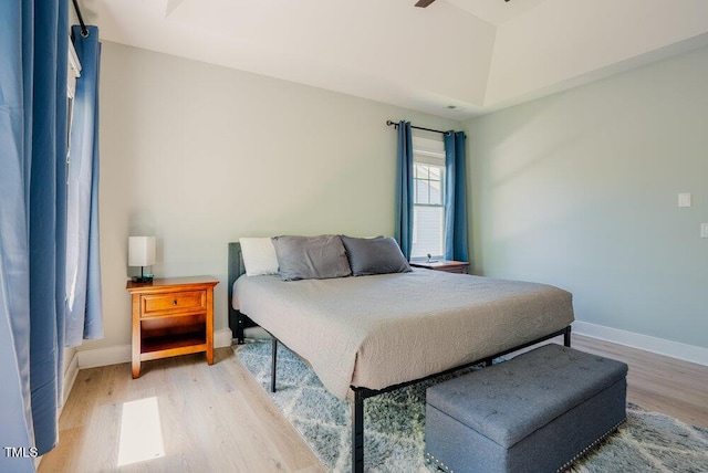 bedroom with light wood finished floors and baseboards