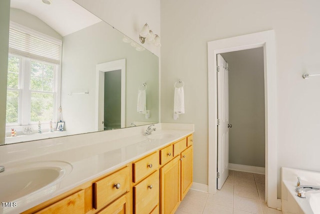 full bathroom with tile patterned floors, double vanity, a bath, and baseboards