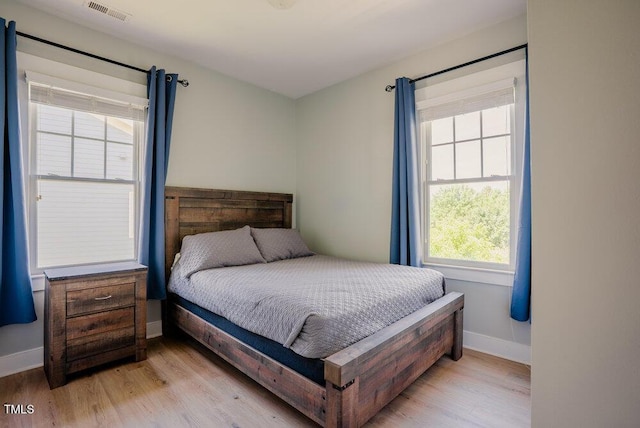 bedroom featuring light wood-type flooring and baseboards