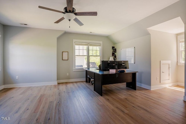 office featuring light wood-type flooring, a ceiling fan, and baseboards