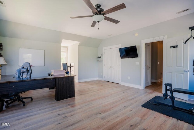 office space featuring light wood finished floors, ceiling fan, vaulted ceiling, and baseboards