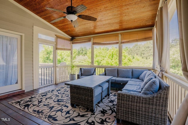 sunroom / solarium featuring lofted ceiling, ceiling fan, and an outdoor hangout area