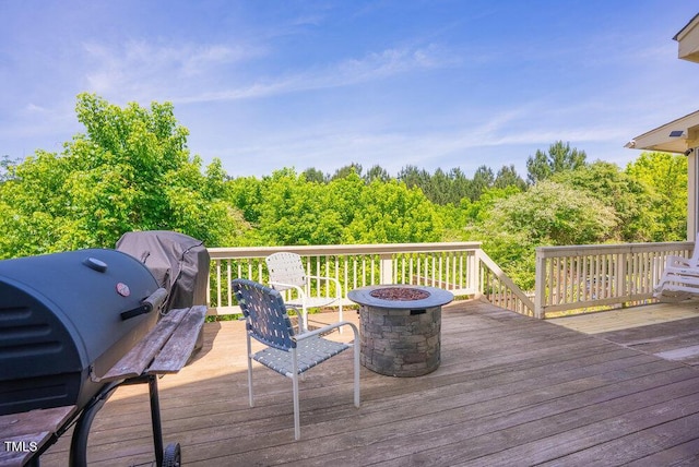 wooden terrace featuring an outdoor fire pit and grilling area