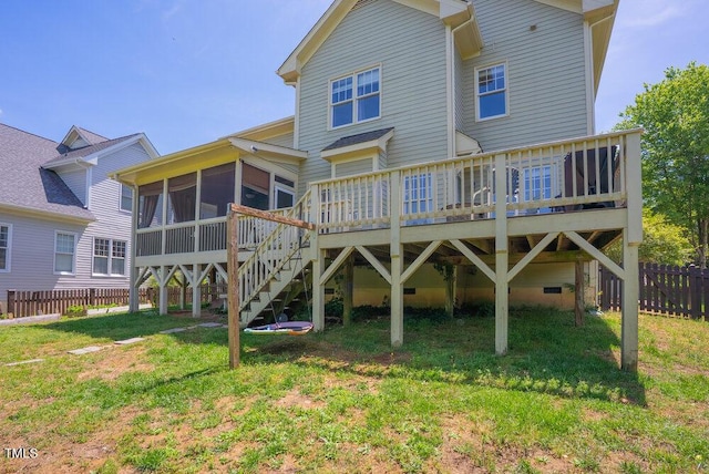 rear view of property with a sunroom, a deck, and stairs