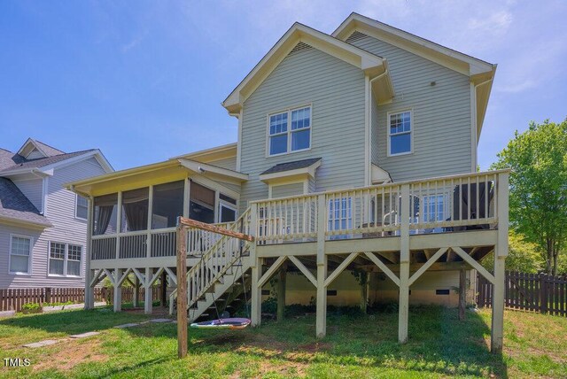 rear view of house with a sunroom, a deck, and stairs