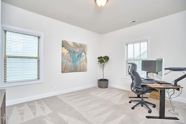 carpeted office featuring baseboards