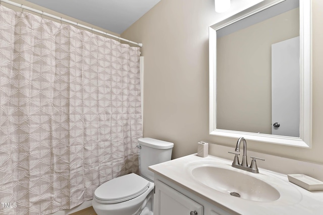 full bathroom featuring toilet, vanity, and a shower with curtain