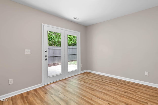 empty room with baseboards and light wood finished floors