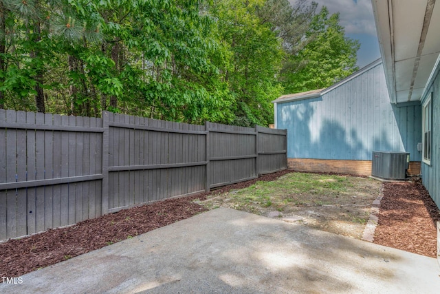fenced backyard with a patio and central AC