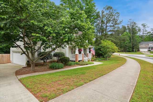 obstructed view of property featuring covered porch, driveway, and an attached garage