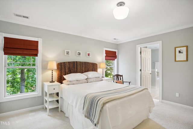 bedroom with light carpet, crown molding, baseboards, and ensuite bathroom