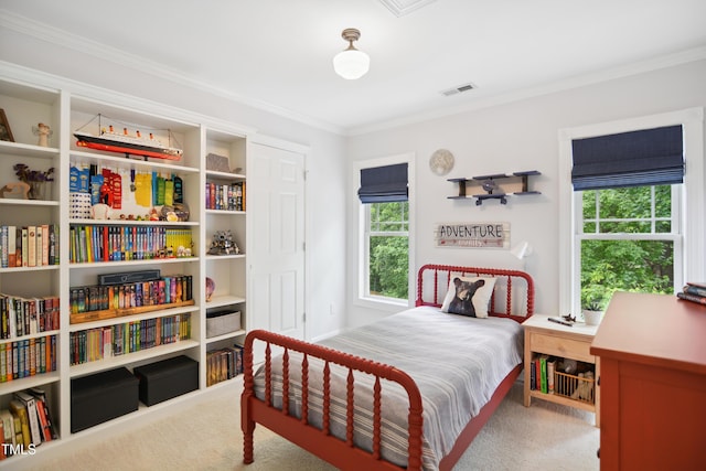 carpeted bedroom with ornamental molding