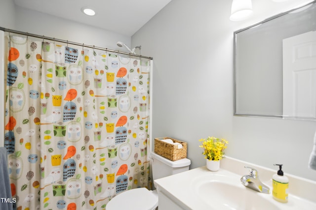 bathroom with toilet, curtained shower, vanity, and recessed lighting
