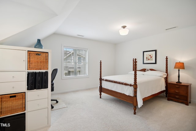 bedroom with light colored carpet, lofted ceiling, and baseboards