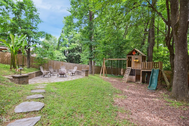 view of yard featuring an outdoor fire pit, a patio area, and a playground